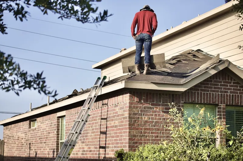 Professional roofer working on a residential roof in Lake Grove